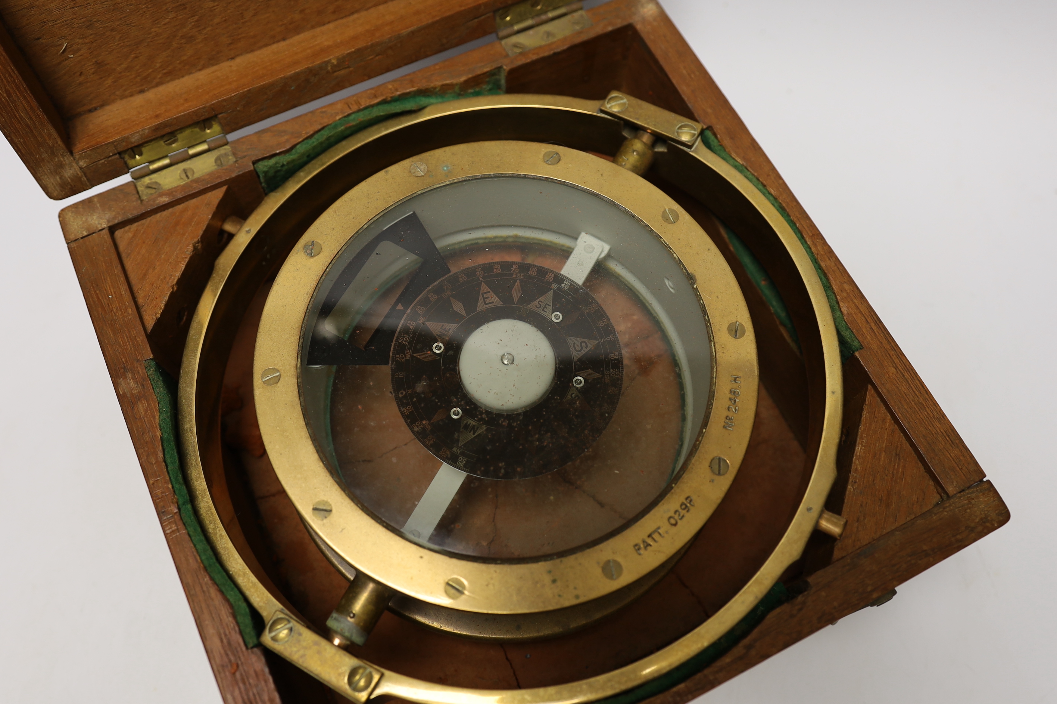 A cased brass compass impressed PATT 029P, 24cm in diameter